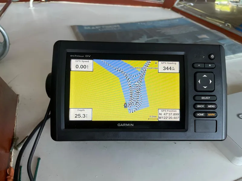 Slide: The Image of Garmin GPS device on 1961 Chris-Craft Conqueror, displaying navigation map and coordinates. - 6