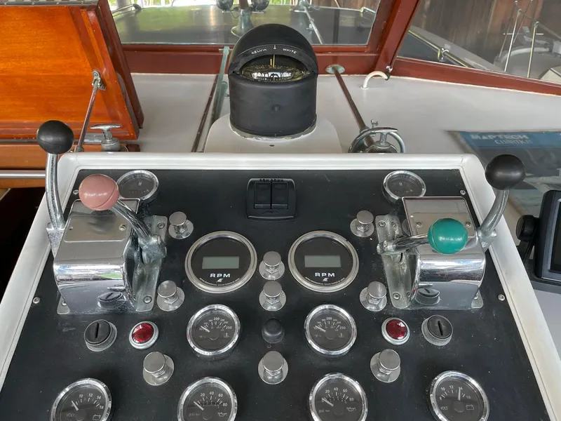 Slide: The Image of 1961 Chris-Craft Conqueror control panel with gauges, levers, and compass. - 7
