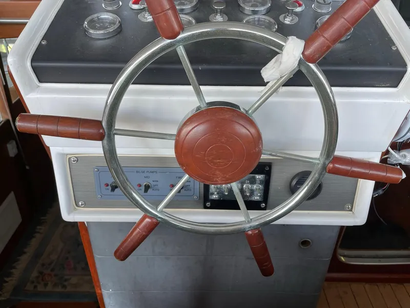 Slide: The Image of 1961 Chris-Craft Conqueror steering wheel and dashboard controls. - 8