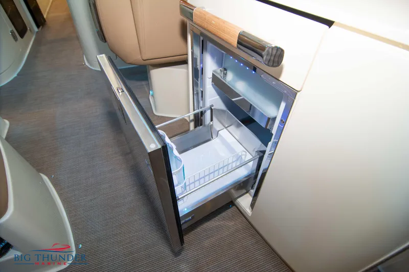 Slide: The Image of 2024 Chris-Craft Launch 35 GT interior with open drawer refrigerator. - 35