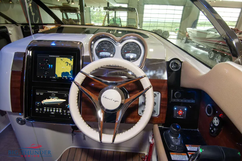 Slide: The Image of 2024 Chris-Craft Launch 35 GT dashboard with steering wheel and navigation display. - 40