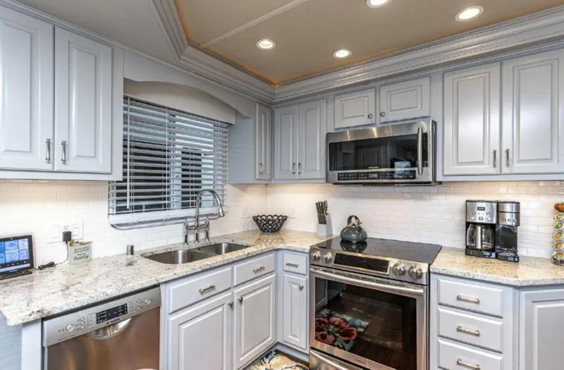 Slide: The Image of Modern kitchen in a 2007 Horizon 18 x 80 houseboat with stainless steel appliances. - 12