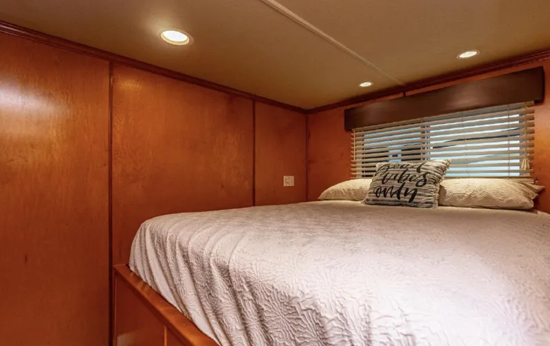 Slide: The Image of Cozy bedroom in 2007 Horizon 18 x 80 houseboat with wood paneling and soft lighting. - 13