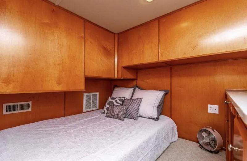 Slide: The Image of Cozy bedroom in 2007 Horizon 18 x 80 houseboat with wooden cabinetry. - 15