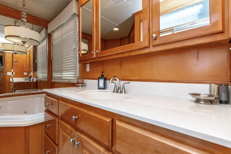 Slide: The Image of Luxurious bathroom in 2007 Horizon 18 x 80 houseboat with wooden cabinets and modern fixtures. - 21