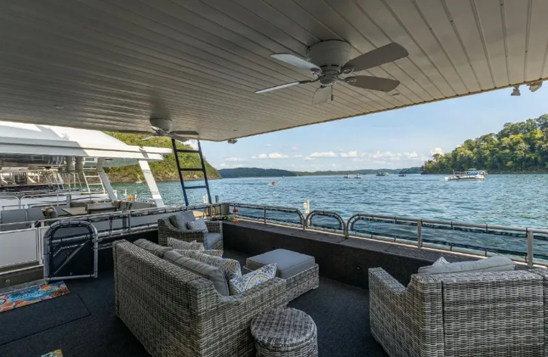 Slide: The Image of Houseboat Horizon 18 x 80 (2007) with outdoor seating area and scenic lake view. - 26