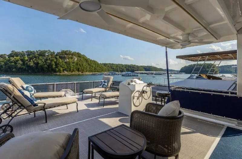 Slide: The Image of Spacious deck of 2007 Horizon 18 x 80 houseboat with lounge chairs and scenic lake view. - 29