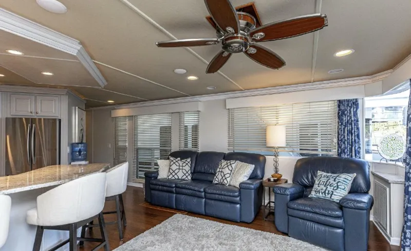 Slide: The Image of Modern living area in a 2007 Horizon 18 x 80 houseboat with leather seating and ceiling fan. - 5