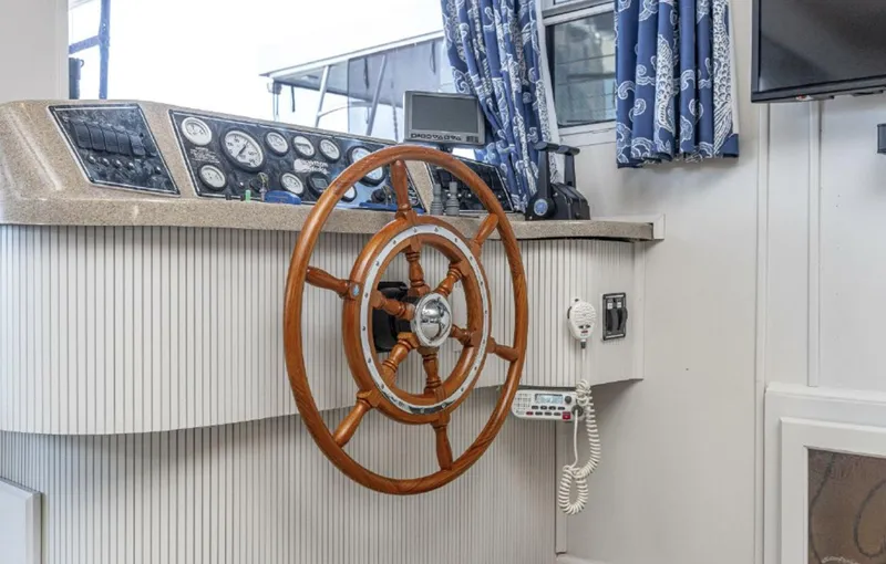 Slide: The Image of 2007 Horizon 18 x 80 boat helm with wooden steering wheel and control panel. - 6