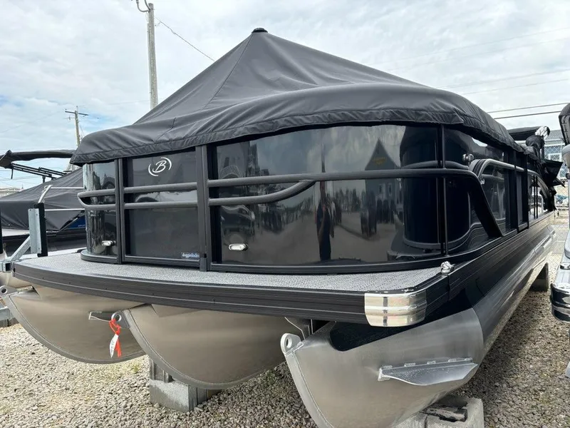Slide: The Image of 2024 Barletta C22UC pontoon boat with black cover on display. - 0