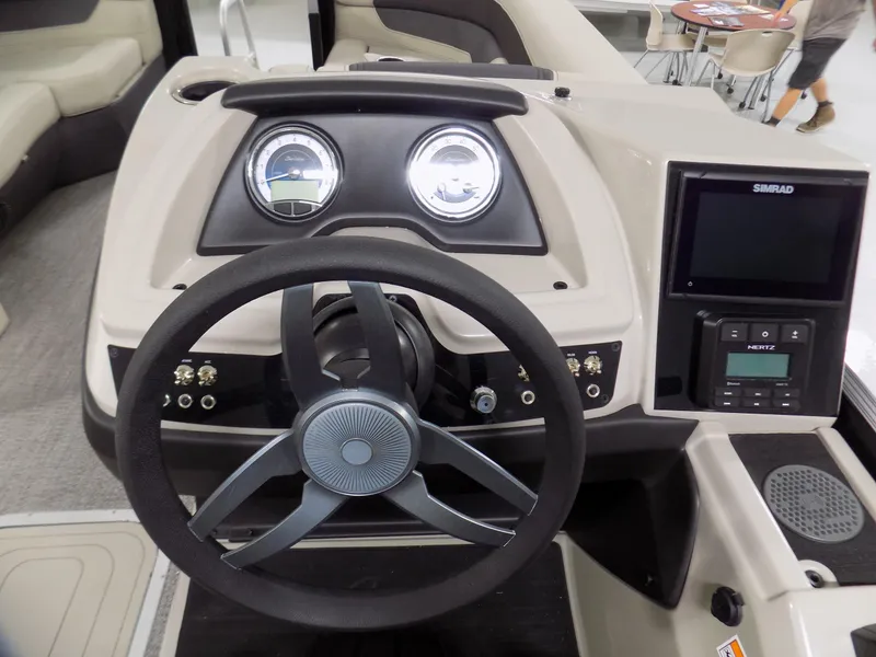 Slide: The Image of 2024 Barletta C22UC boat dashboard with steering wheel and control panel. - 11