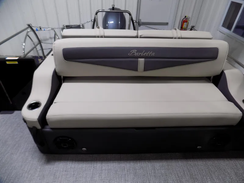 Slide: The Image of 2024 Barletta C22UC boat interior with beige seating and cup holders. - 12