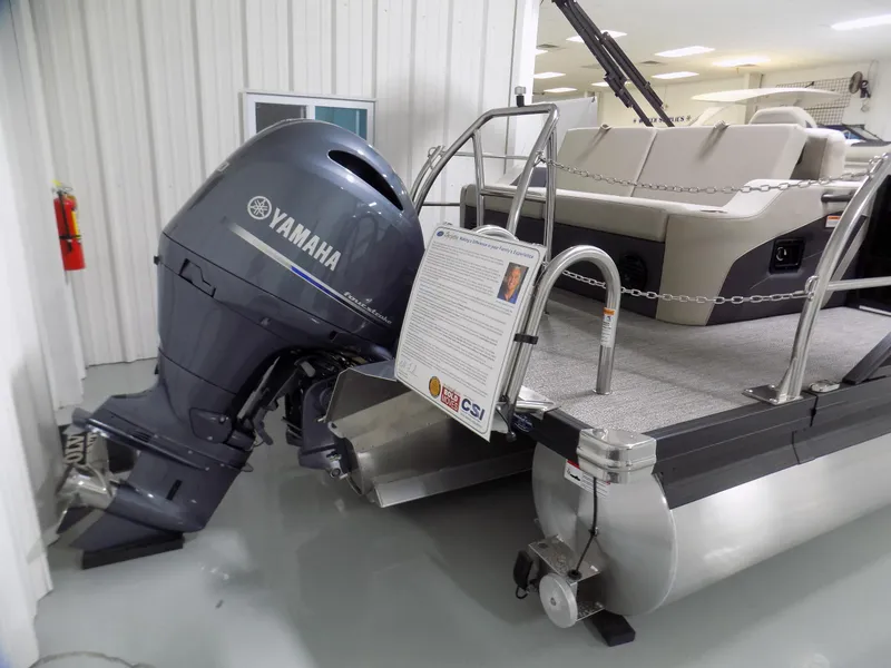 Slide: The Image of 2024 Barletta C22UC pontoon boat with Yamaha outboard motor in showroom. - 15