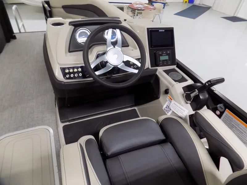 Slide: The Image of 2024 Barletta C22UC boat cockpit with steering wheel and control panel. - 9