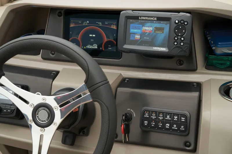 Slide: The Image of 2024 Sun Tracker SportFish 22 XP3 dashboard with steering wheel and Lowrance fishfinder. - 34