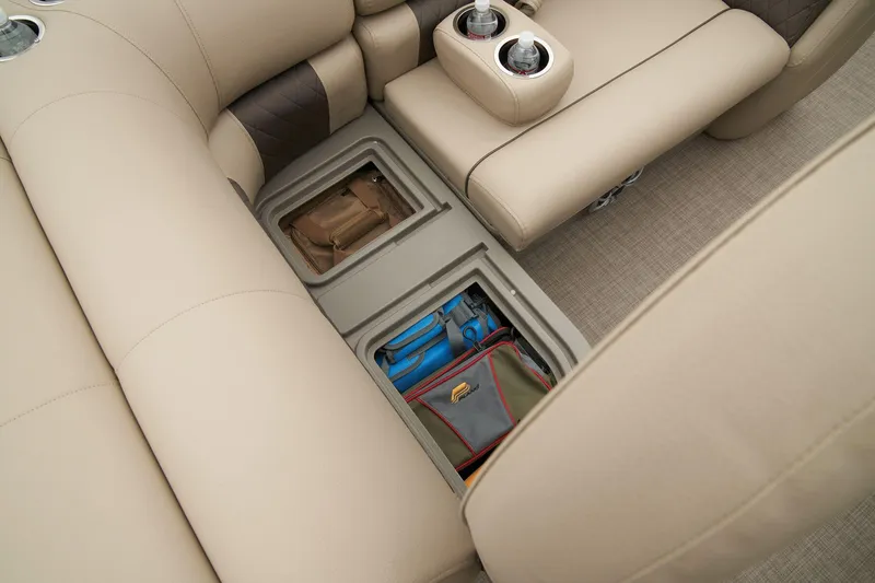 Slide: The Image of Sun Tracker SportFish 22 XP3 2024 interior storage compartments with beige seating. - 46