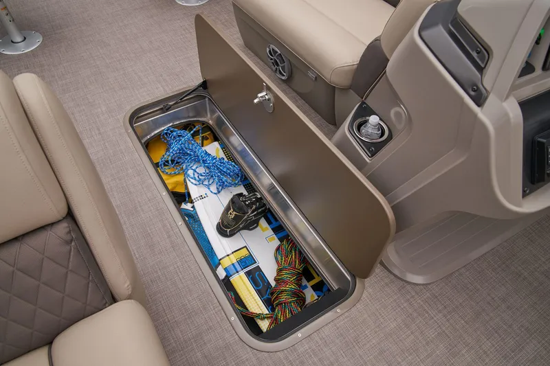 Slide: The Image of 2024 Sun Tracker Fishin' Barge 22 XP3 storage compartment with fishing gear and accessories. - 30