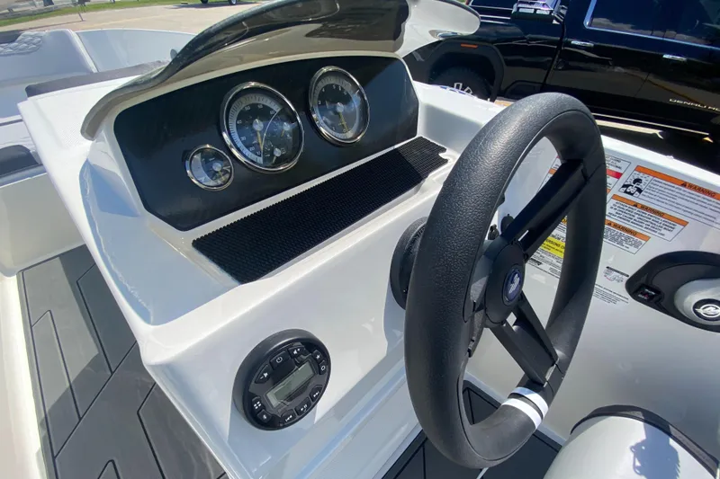 Slide: The Image of 2024 Bayliner Element M19 boat dashboard with steering wheel and gauges. - 8
