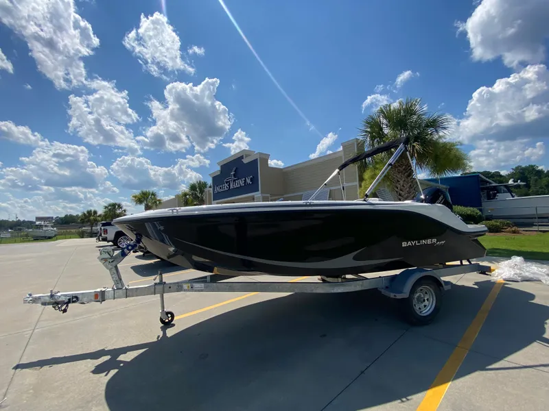 Slide: The Image of 2024 Bayliner Element M19 boat on a trailer under a sunny sky. - 0