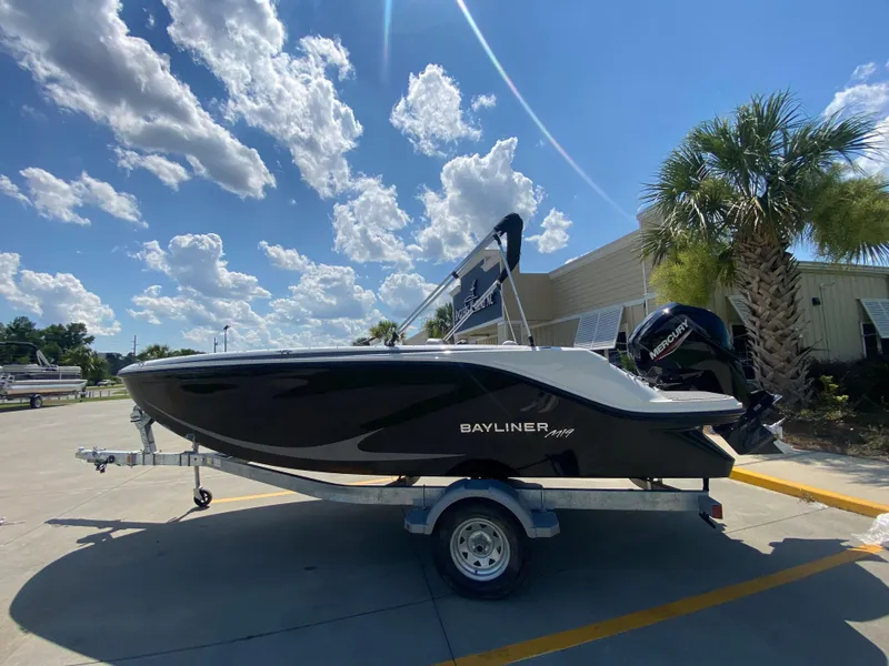 Slide: The Image of 2024 Bayliner Element M19 boat on trailer under sunny sky. - 4