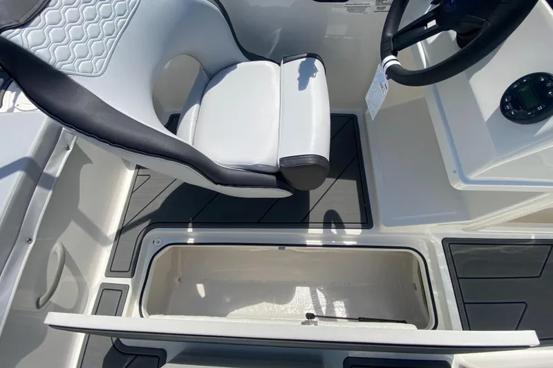 Slide: The Image of 2024 Bayliner Element M19 boat interior with storage compartment and captain's seat. - 6