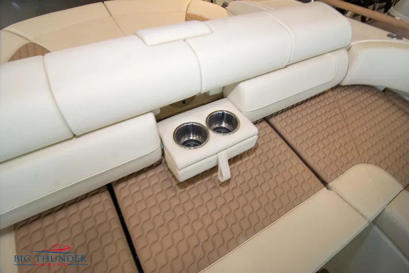Slide: The Image of 2023 Chris-Craft Launch 31 GT boat interior with beige seating and cup holders. - 23