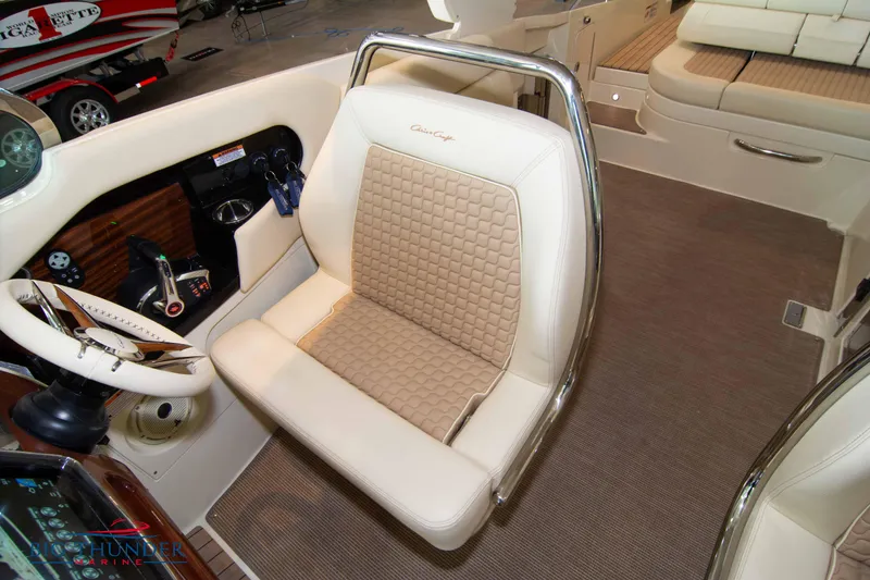 Slide: The Image of 2023 Chris-Craft Launch 31 GT boat interior with beige leather seating and steering wheel. - 47