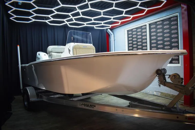 The Image of 2023 Savannah SS19 boat on trailer in showroom with modern lighting. - 0