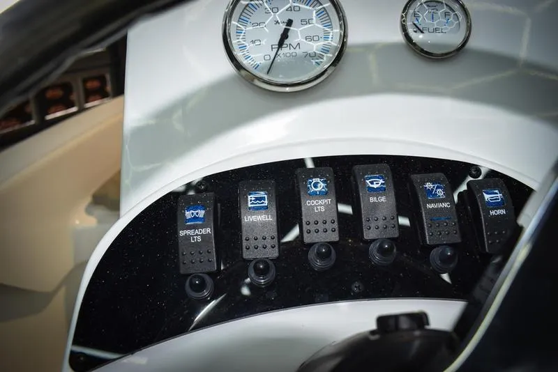 Slide: The Image of Control panel of 2023 Savannah SS19 boat with switches and gauges. - 13