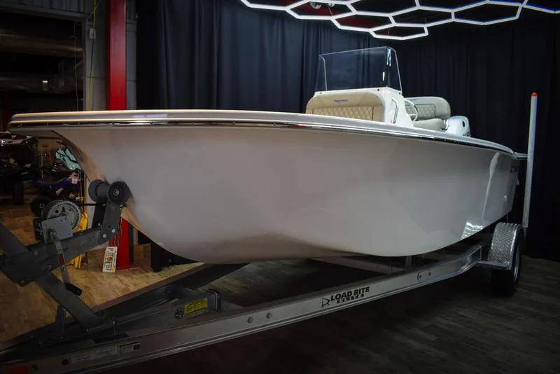 Slide: The Image of 2023 Savannah SS19 boat on Load Rite trailer in showroom. - 2