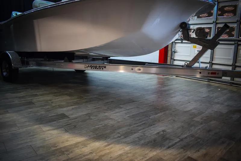 Slide: The Image of Savannah SS19 boat 2023 model on Load Rite trailer in a garage. - 24