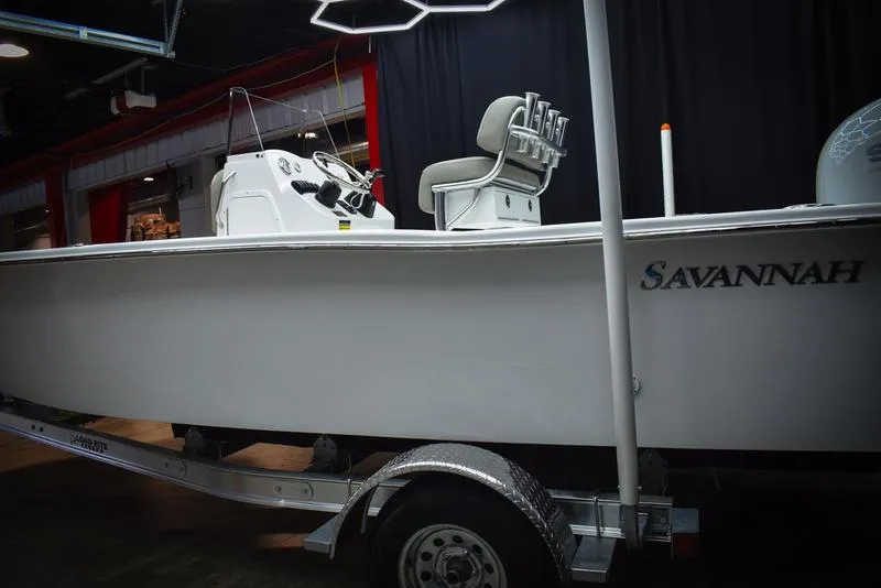 Slide: The Image of 2023 Savannah SS19 boat on trailer in showroom. - 3