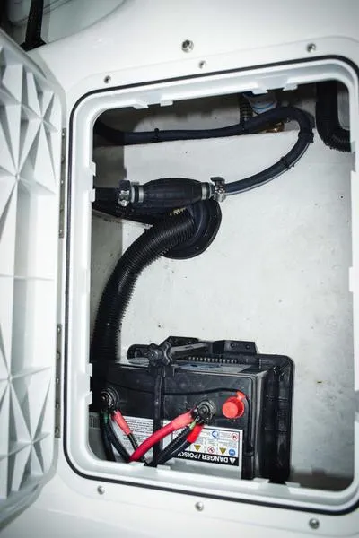Slide: The Image of Battery compartment of 2023 Savannah SS19 boat with wiring and hoses. - 9