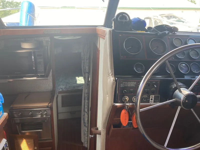 Slide: The Image of Interior of a 1984 Bayliner 3270 Command Bridge boat showing the helm and galley. - 12