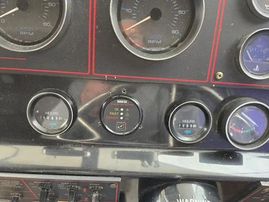Slide: The Image of 1984 Bayliner 3270 Command Bridge dashboard with RPM and hour gauges. - 15
