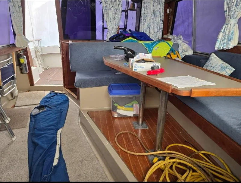 Slide: The Image of Interior of 1984 Bayliner 3270 Command Bridge with seating, table, and nautical equipment. - 21