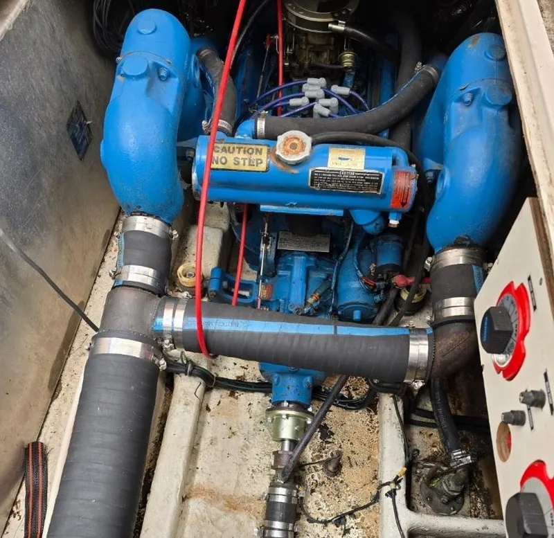 Slide: The Image of Engine compartment of a 1984 Bayliner 3270 Command Bridge boat, featuring blue engine components. - 22