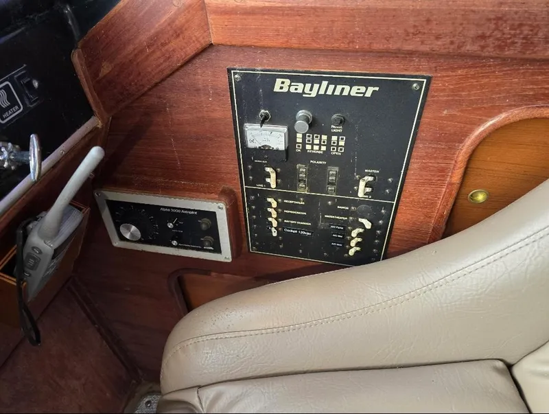 Slide: The Image of Control panel of 1984 Bayliner 3270 Command Bridge with switches and gauges. - 24