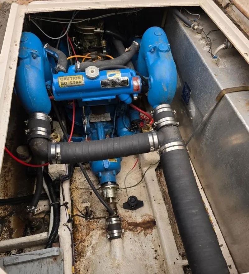 Slide: The Image of Engine compartment of 1984 Bayliner 3270 Command Bridge with blue engine components. - 25