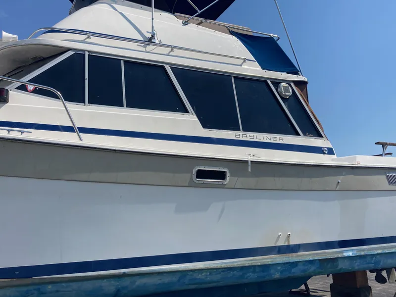 Slide: The Image of 1984 Bayliner 3270 Command Bridge boat on dry dock. - 3