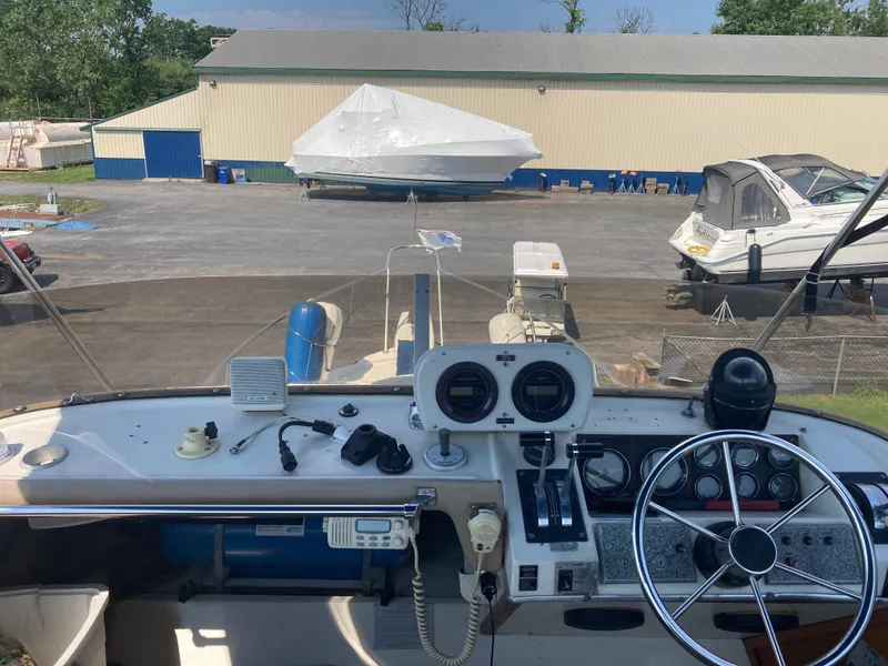 Slide: The Image of 1984 Bayliner 3270 Command Bridge helm with marina view. - 5