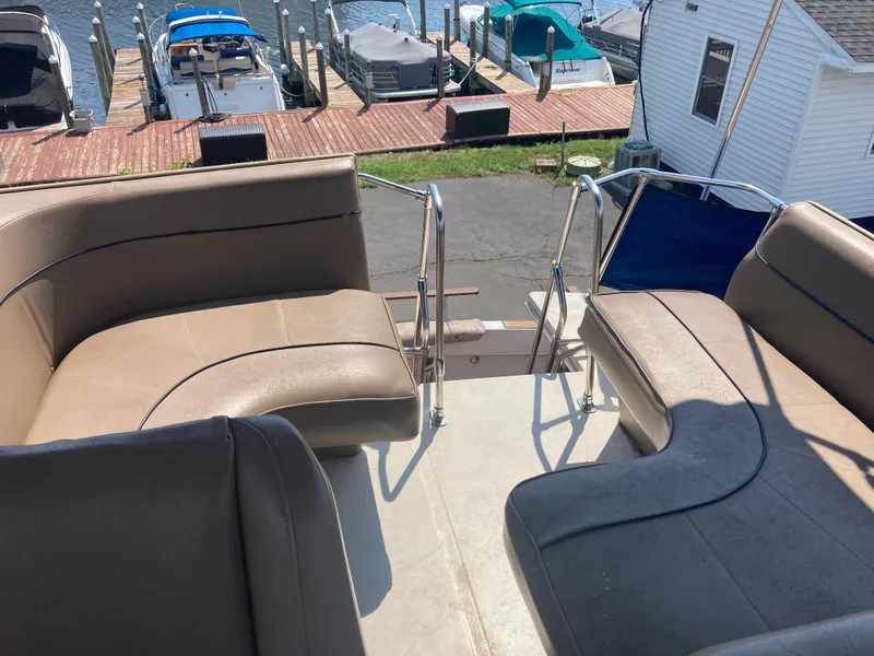 Slide: The Image of 1984 Bayliner 3270 Command Bridge seating area with marina view. - 7
