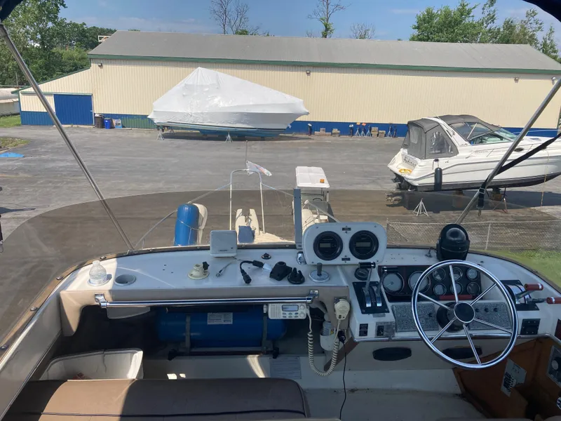 Slide: The Image of 1984 Bayliner 3270 Command Bridge cockpit with steering wheel and control panel. - 9