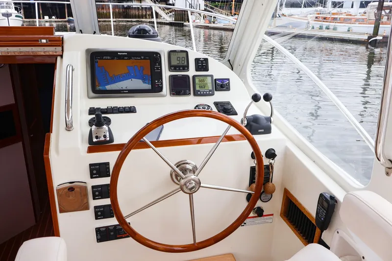 Slide: The Image of Helm station of 2010 MJM 40z Downeast boat with navigation equipment and wooden steering wheel. - 10