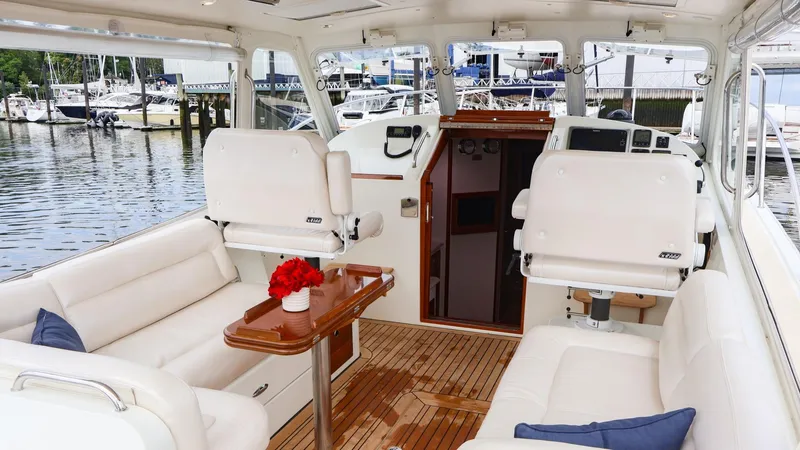 Slide: The Image of 2010 MJM 40z Downeast boat interior with white seating and wooden flooring. - 11