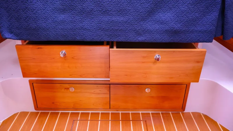 Slide: The Image of Wooden storage drawers on 2010 MJM 40z Downeast boat with blue bedspread. - 28