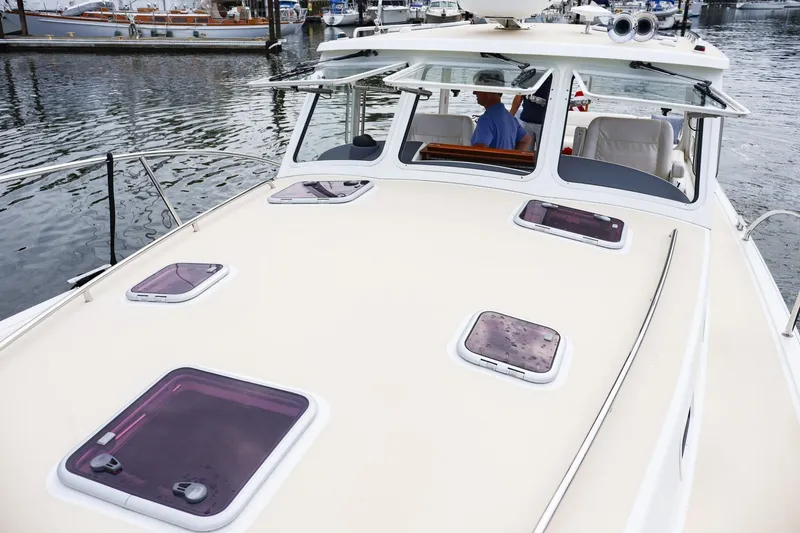 Slide: The Image of 2010 MJM 40z Downeast boat docked at marina, view of deck and cabin. - 5