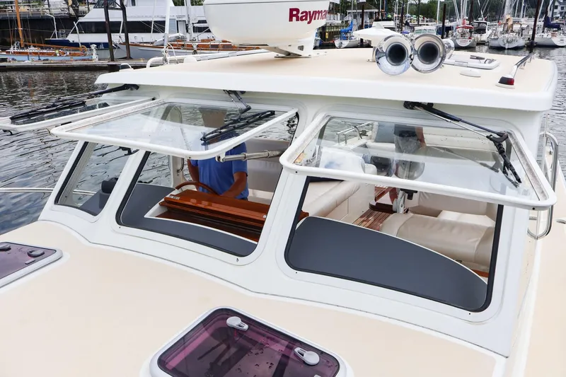 Slide: The Image of 2010 MJM 40z Downeast boat with open windows docked at marina. - 6