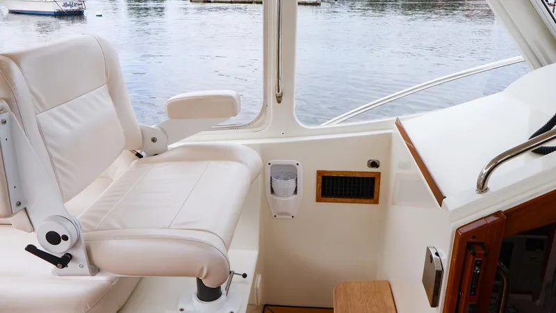 Slide: The Image of Captain's chair on 2010 MJM 40z Downeast boat, overlooking calm waters. - 8