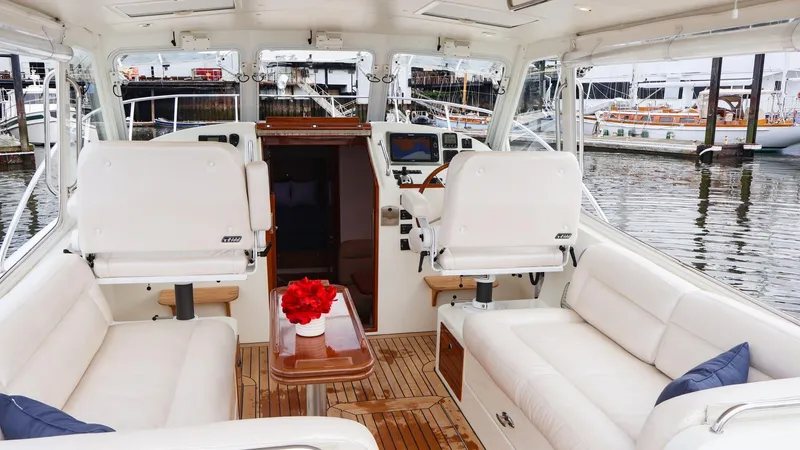 Slide: The Image of Luxurious interior of a 2010 MJM 40z Downeast yacht with white seating and wooden accents. - 9